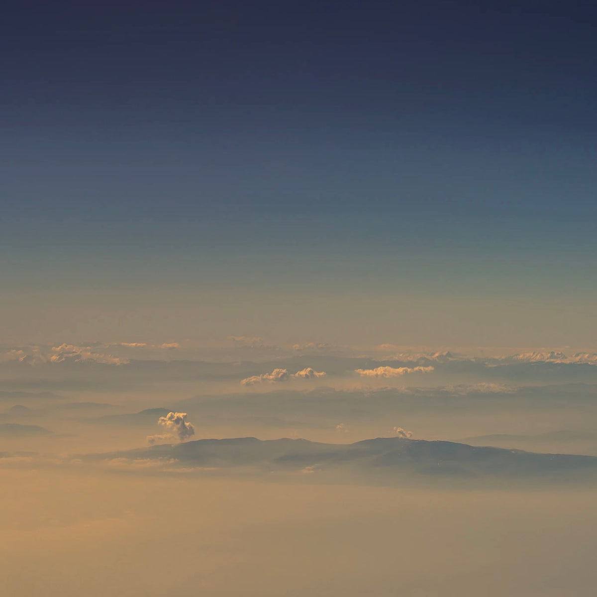 Clouds in a hazy blue and orange sky
