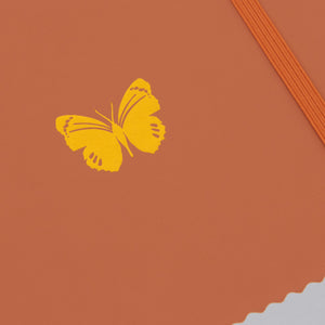 burnt orange butterfly zoom in on emblem