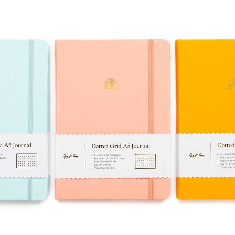 All three cloud bullet journals: eggshell blue, pastel peach and sunshine yellow