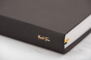 Close up of Yop & Tom logo on spine of power of 3 goal planner in charcoal