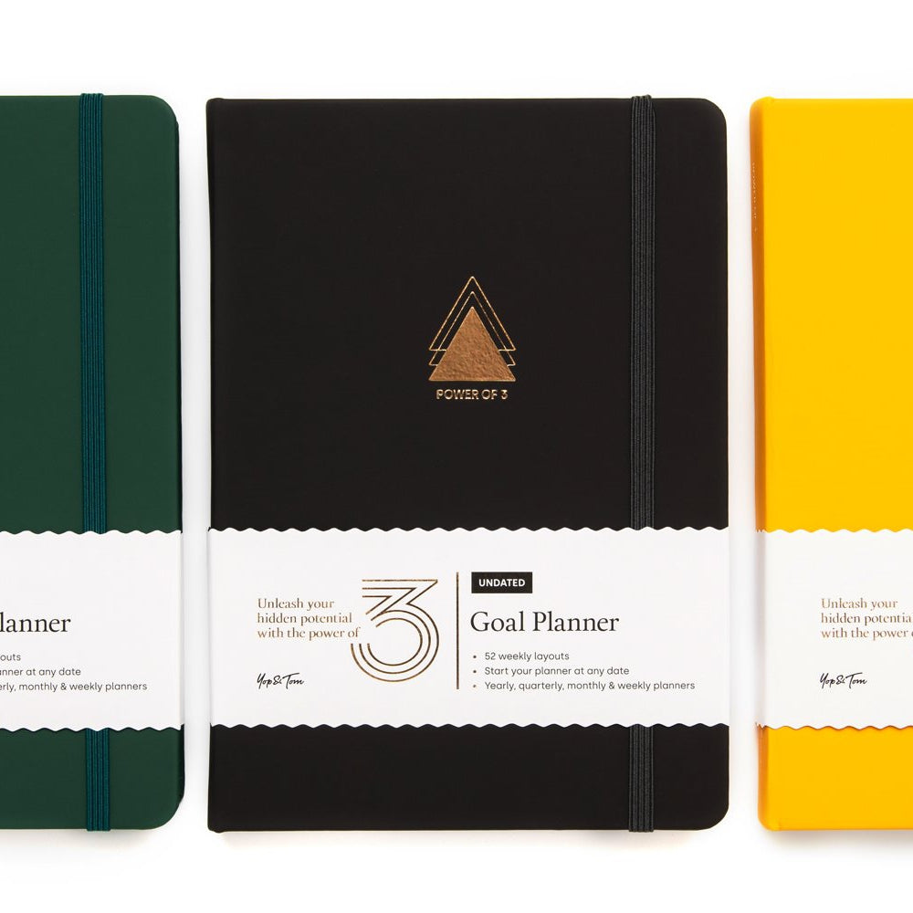 Power of 3 goal planners in charcoal, green and yellow