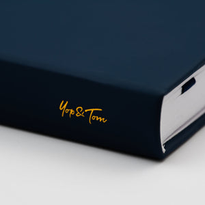 yop & tom logo on spine of dark blue journal