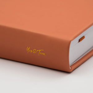 burnt orange Yop & Tom logo on spine